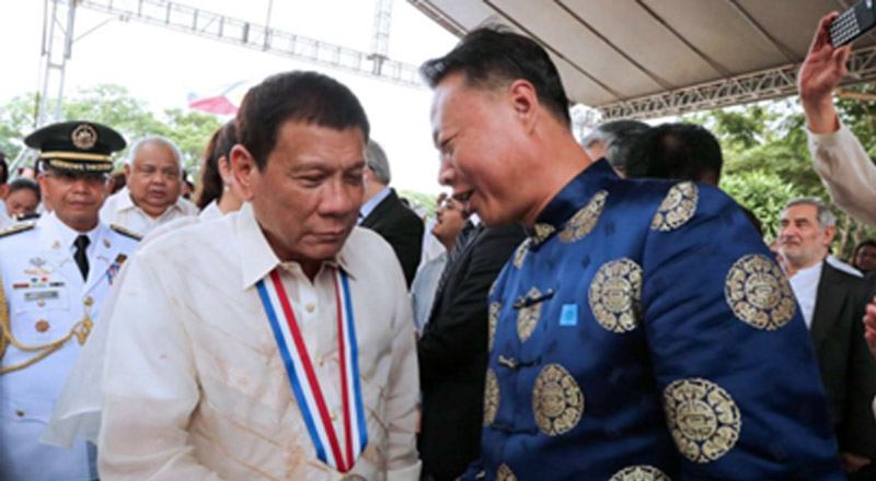 President Rodrigo Duterte shakes hands with Chinese Ambassador to the Philippines Zhao Jianhua. Photo: EPA